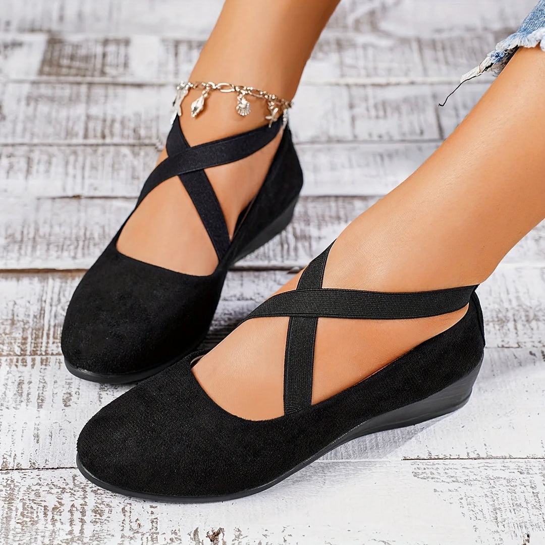 Black cross strap low wedge flat, three-quarter angle view