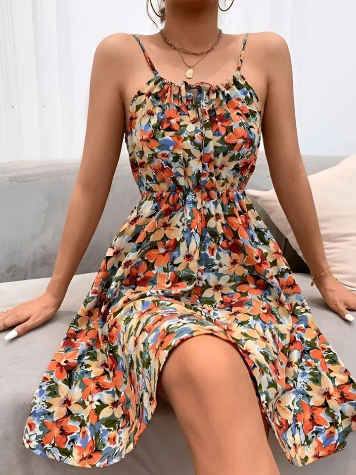 Woman in a pink floral halter sundress turned three-quarters to the right