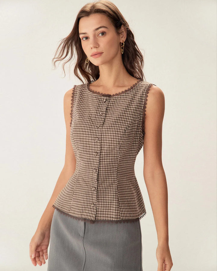 Woman facing forward wearing a brown gingham top with lace trim detailing