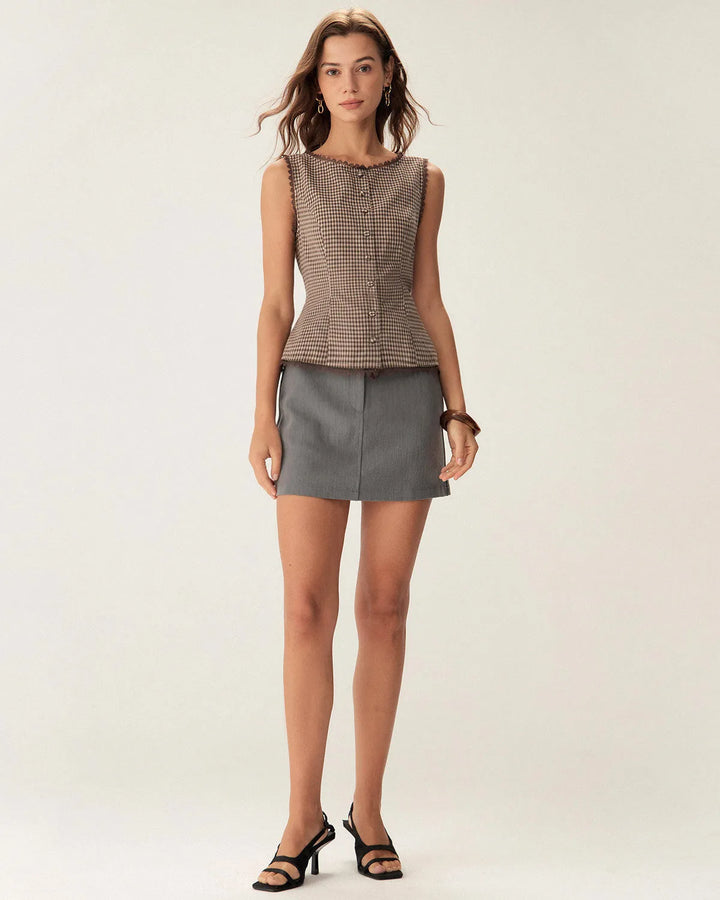 Side view of a woman wearing a brown gingham top with lace trim