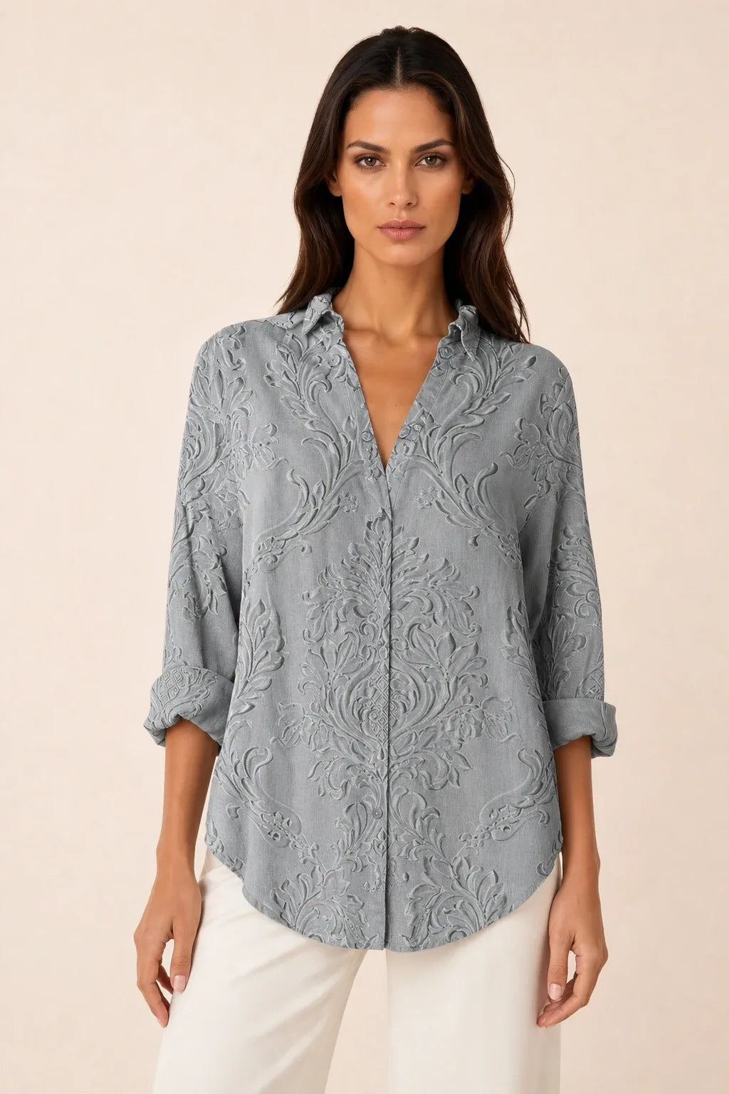 Gray embossed floral blouse on model in contrapposto stance, front view