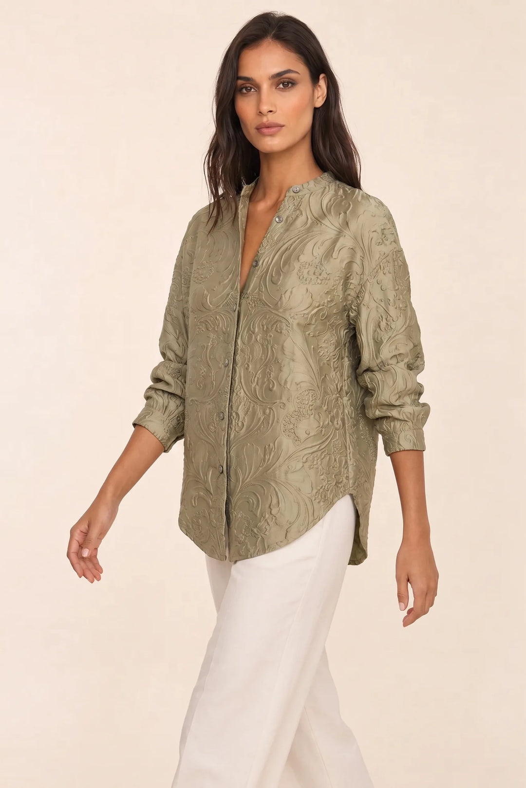 Green embossed floral blouse on model in three-quarter turn