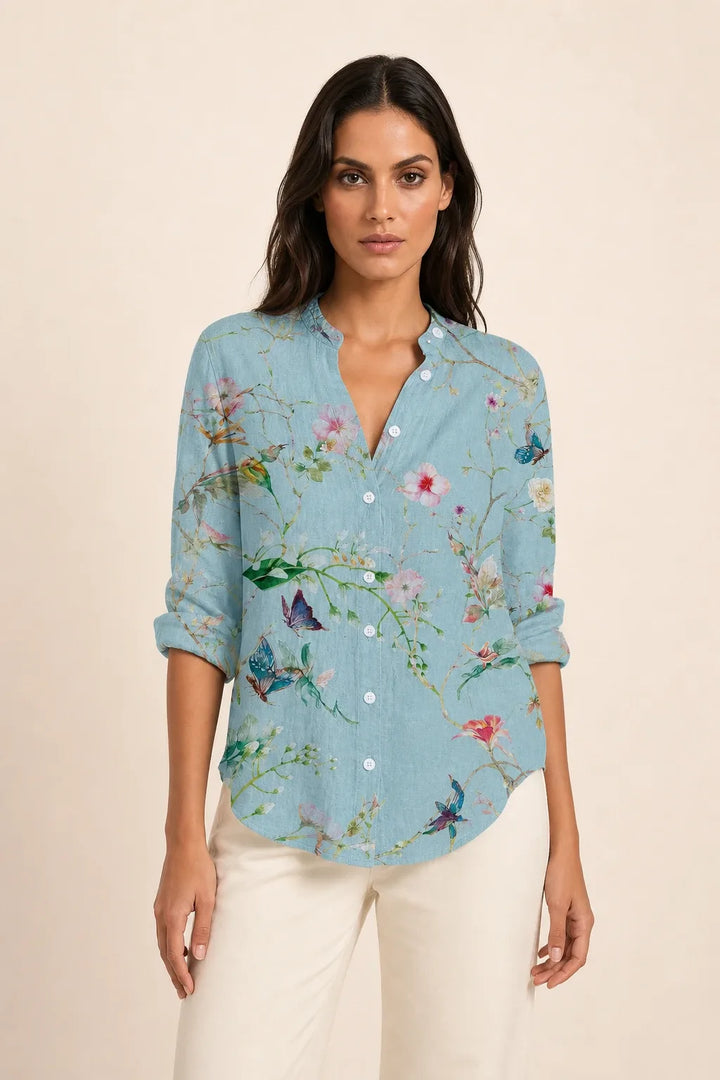 Light blue embossed floral blouse on model in contrapposto stance, front view