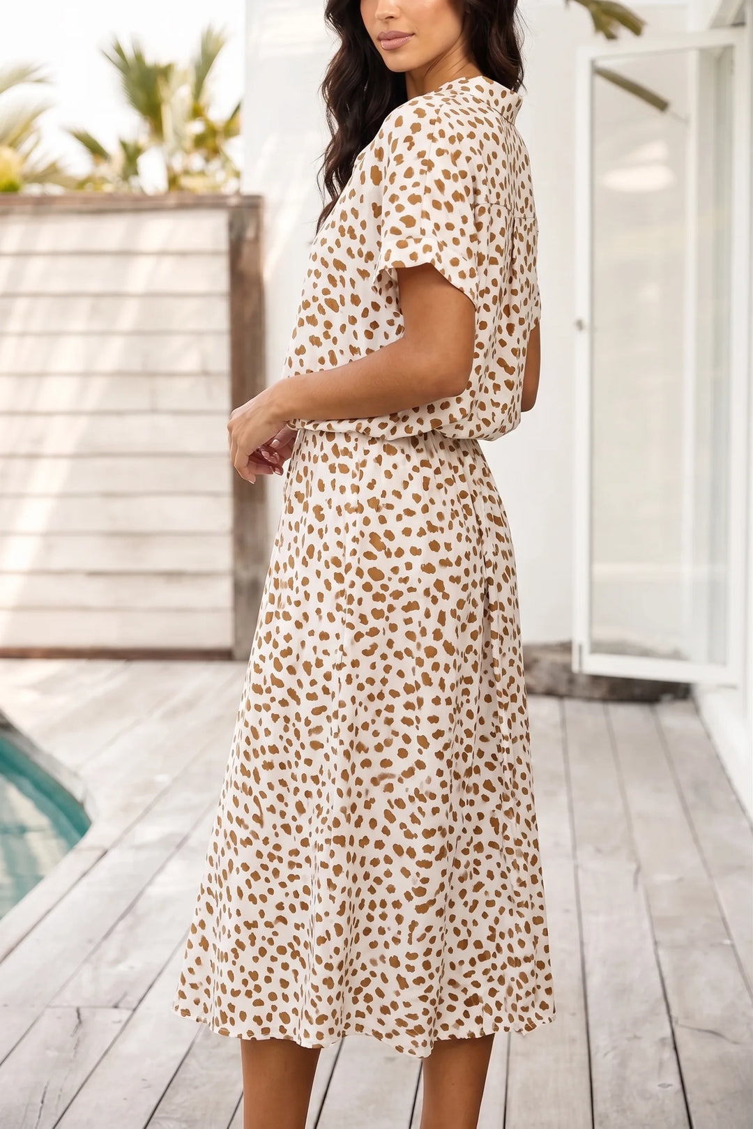 Beige spotted print midi dress on model in three-quarter turn