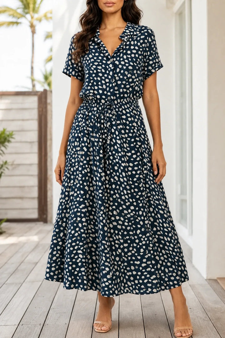 Navy blue spotted print midi dress on model in contrapposto stance
