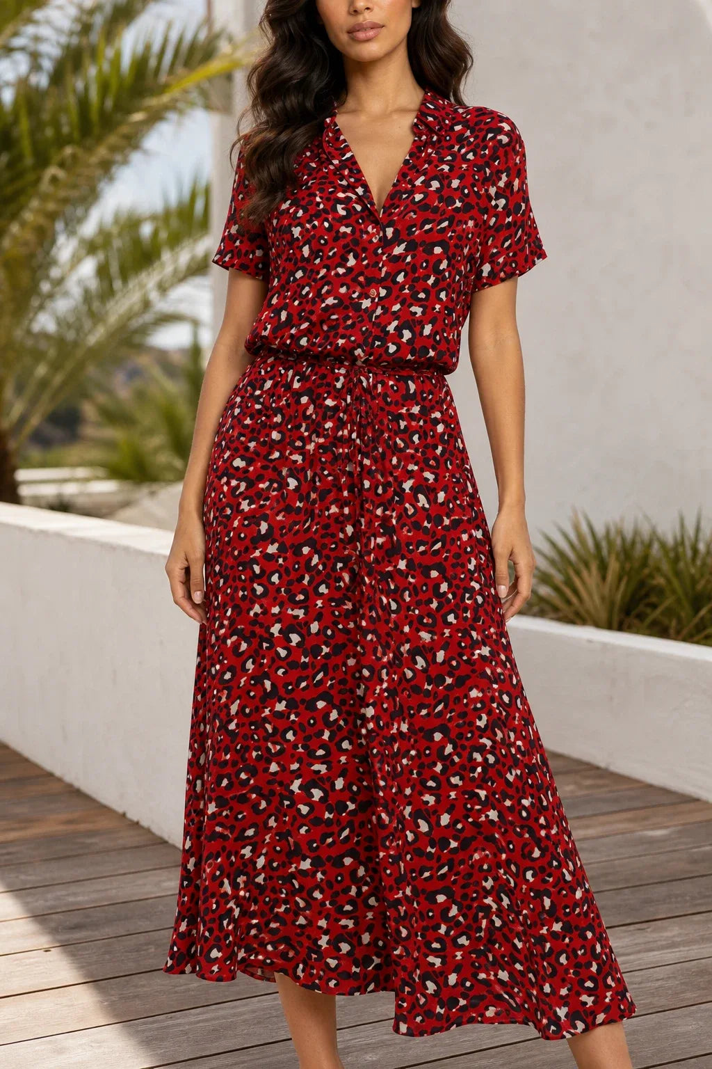 Red spotted print midi dress on model in contrapposto stance