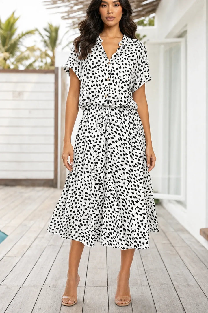 White spotted print midi dress on model in contrapposto stance