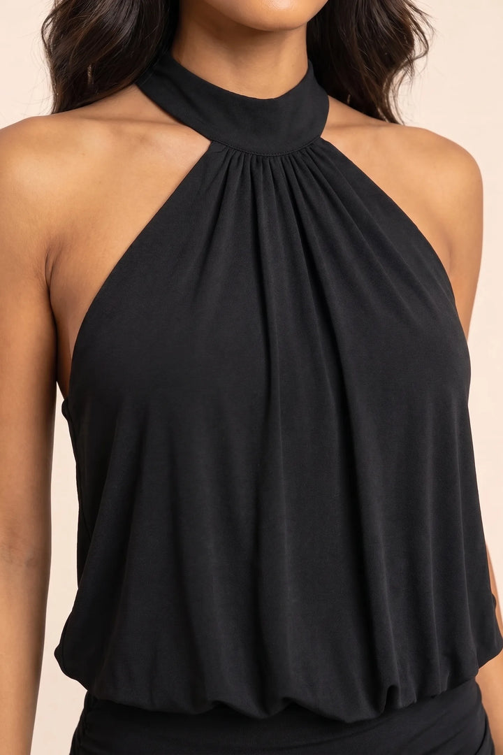 Close-up detail of black halter blouson mini dress