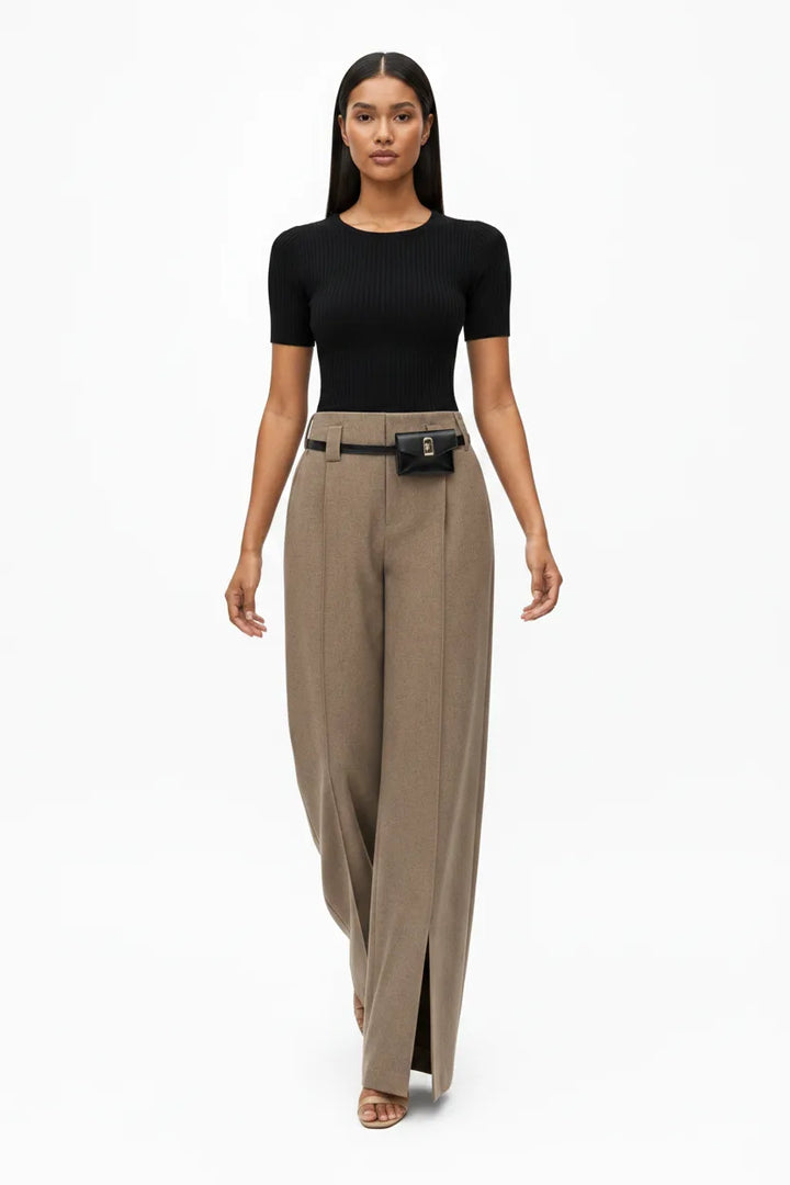Khaki wide-leg belted trousers on model captured in natural movement