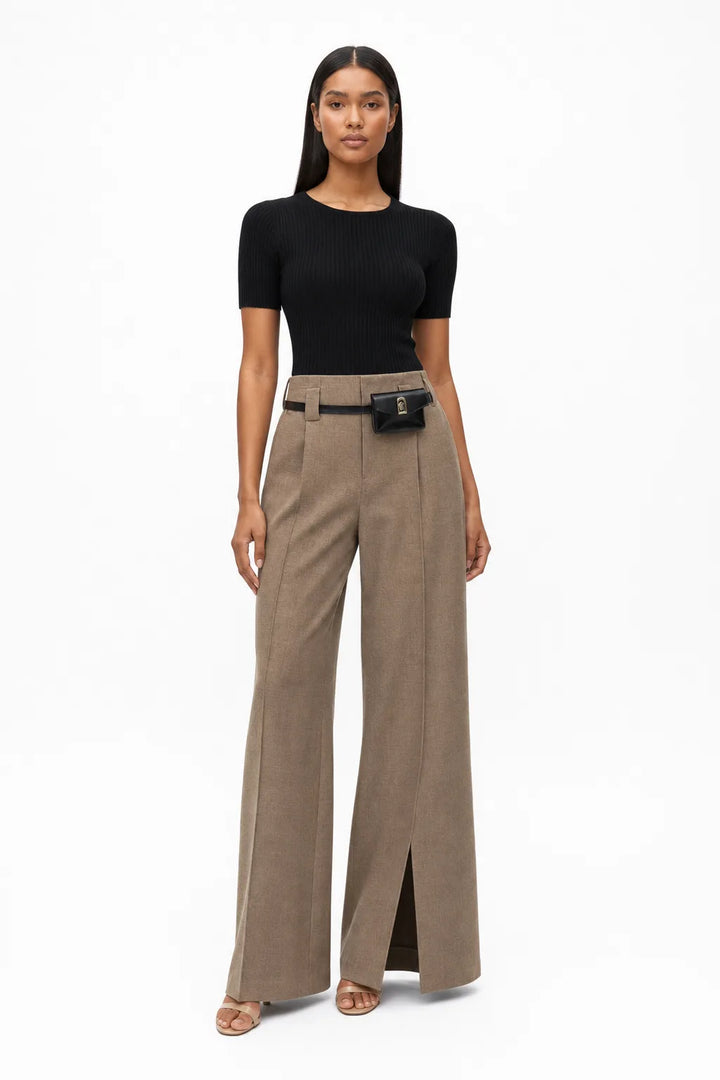 Khaki wide-leg trousers with belt worn by model in contrapposto stance
