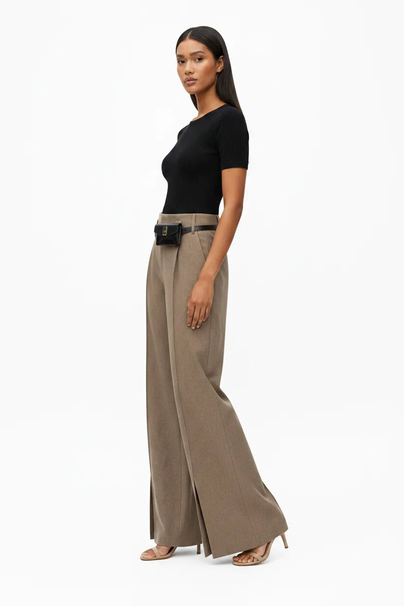 Khaki wide-leg belted trousers on model at three-quarter turn