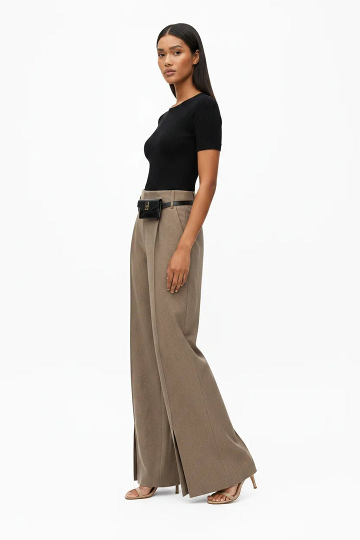Khaki wide-leg belted trousers on model at three-quarter turn