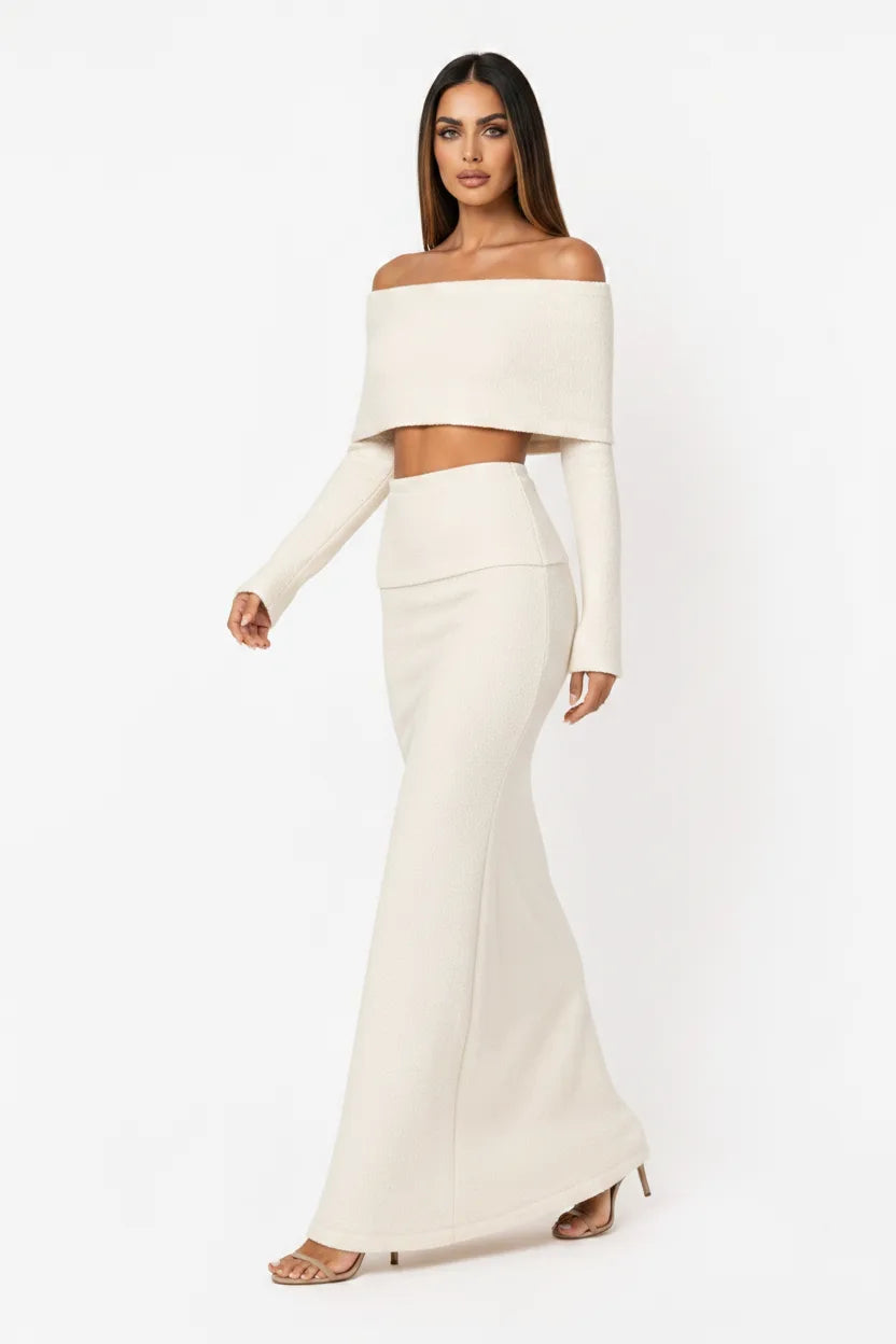White off-shoulder knit crop top and skirt set on model in natural movement pose