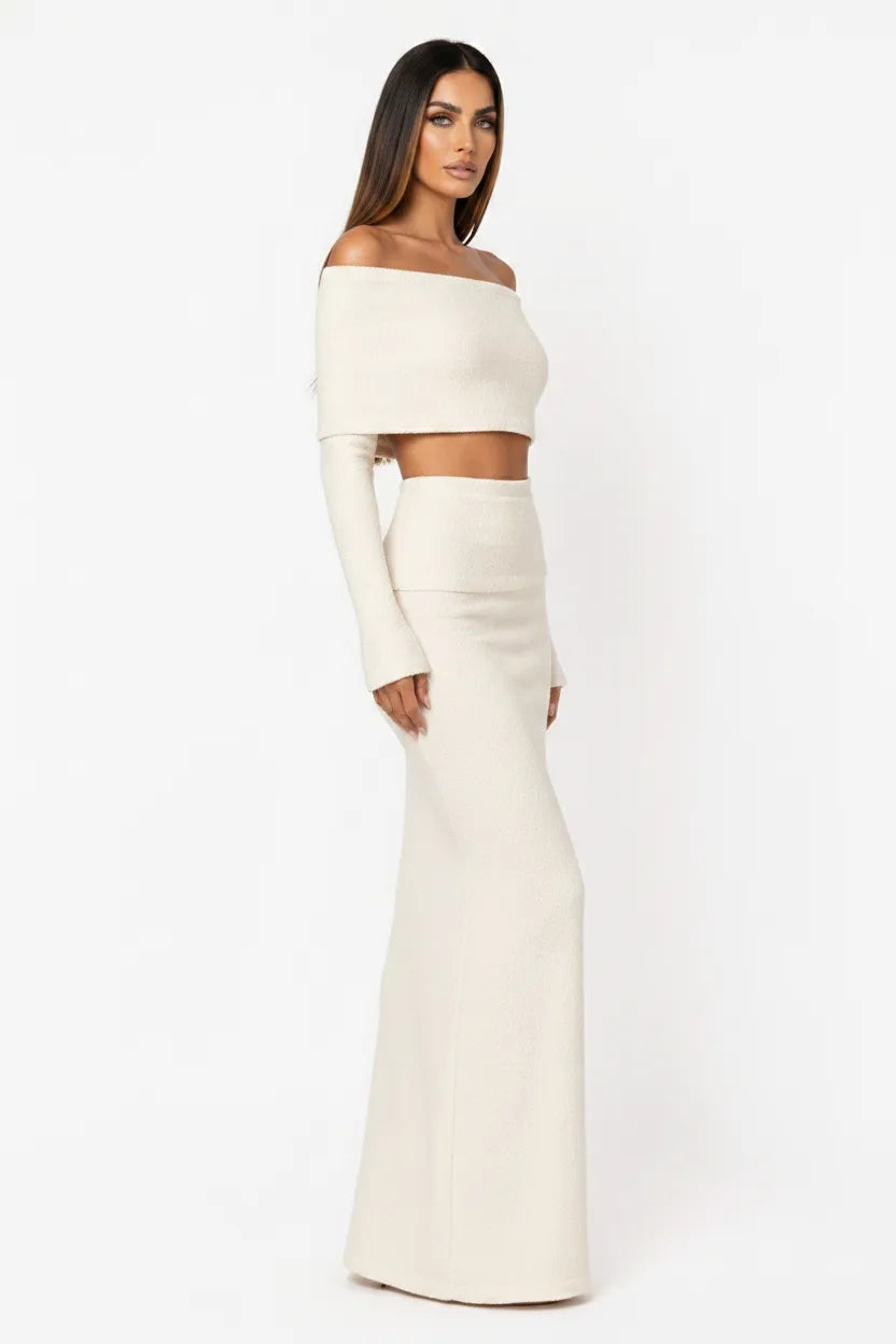 White off-shoulder knit crop top and skirt set on model in three-quarter turn