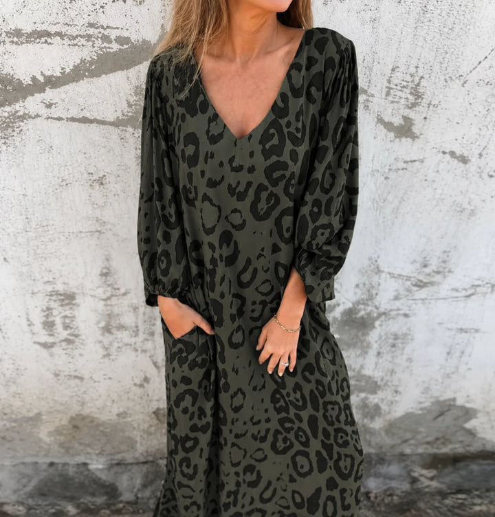 Dark green leopard print maxi dress shown from the front on a standing model