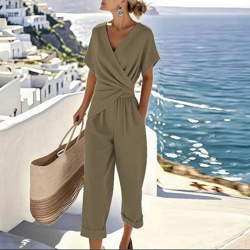 Woman in a khaki sleeveless twisted wrap jumpsuit shown from the side